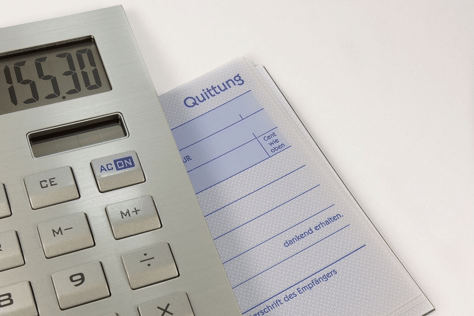 Imagem mostra calculadora acima de cardeneta de finanças., Foto ilustrativa do crescimento da inadimplência em Porto Alegre.
